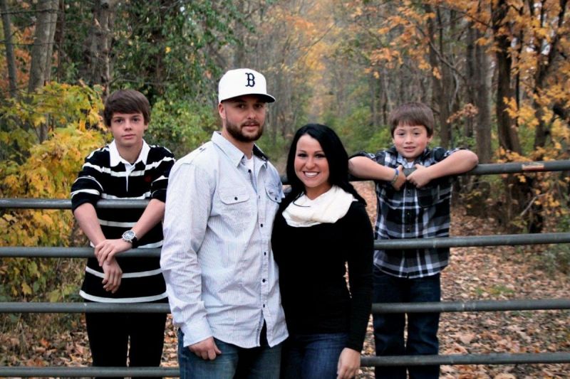 family posing by fence