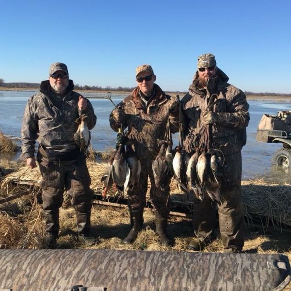 men posing with killed ducks