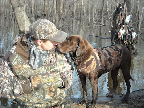 dog near owners face with dead birds in background